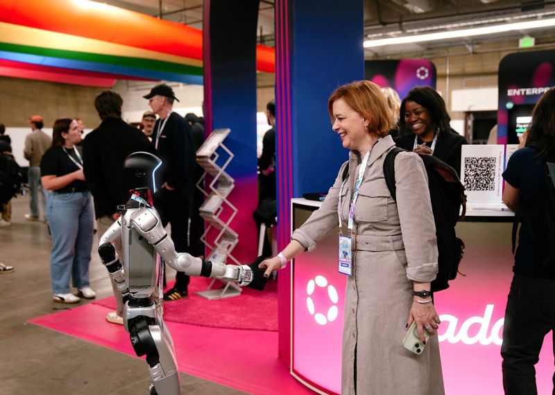 Chrissy Hill at ETH Denver, with a robot handshake illustrating AI governance and infrastructure for digital trust
